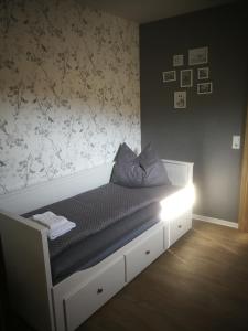 a bedroom with a bed with a light on it at AppartementHaus Nienburg in Nienburg