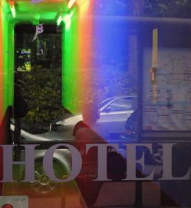 a reflection of a person in a window with a rainbow at City View Hotel in London