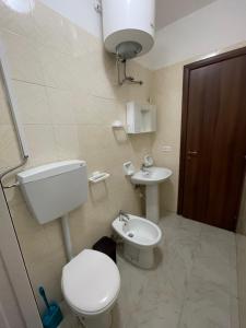 a bathroom with a toilet and a sink at Appartamenti Bella Vista in Lampedusa