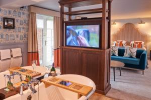 a living room with a television in a room at Hotel Du Vin Poole in Poole