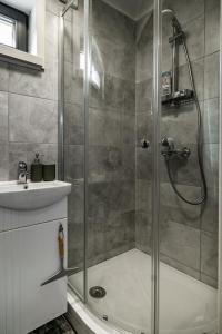 a bathroom with a shower and a sink at Jūras dzintars in Ainaži