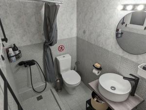 a small bathroom with a toilet and a sink at Cozy apartm.near Metro Ag.Marina in Athens