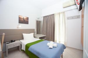 Postel nebo postele na pokoji v ubytování Aristea Hotel