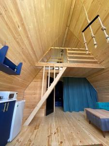 a bed in a room with a wooden ceiling at Cozy Hills in Borjomi