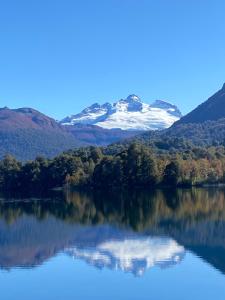 a view of a lake with a snow covered mountain at Los Amancay del Otto in San Carlos de Bariloche