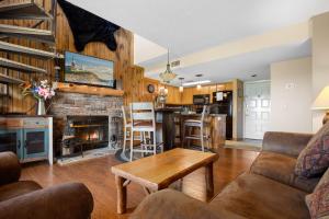 a living room with a couch and a fireplace at Deer Ridge Mountain Resort E308 in Gatlinburg