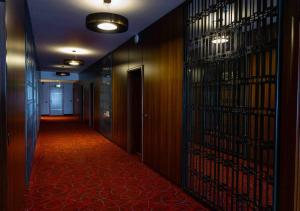 un couloir avec un long couloir aux murs en bois dans l'établissement Hotel Sirius, à Pristina
