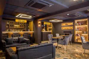 a bar with couches and tables in a restaurant at THE LEA HOTELS & SUITE in Didim