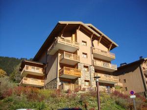 a large building with balconies on the side of it at Appartement cosy avec piscine - 4 pers, balcon, parking - près des Saisies - FR-1-594-156 in Villard-sur-Doron