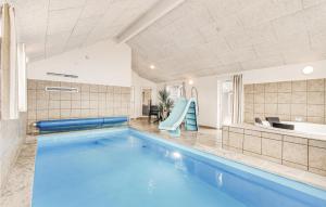 a swimming pool with a slide in a house at 8 Bedroom Beautiful Home In Bogense in Bogense