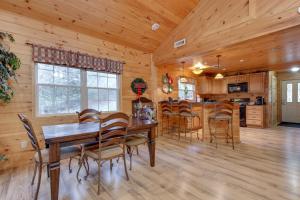 a dining room and kitchen in a log cabin at A Garden Blessing, 1 Bedroom, Hot Tub, Fireplace, Grill, WiFi, Sleeps 4 in Gatlinburg