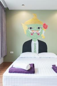 a mural of a man in a suit and hat on a bed at 99 Hostel Khaosan in Bangkok