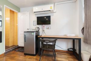 a small kitchen with a counter and a refrigerator at 99 Hostel Khaosan in Bangkok