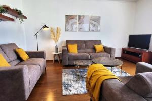 a living room with two couches and a tv at SUN apartment with SEA VIEW and shared POOL in Split