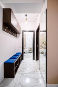 a hallway with a blue bench in a bathroom at Seaside Blues Apartment Located in 5 Star Resort in Năvodari