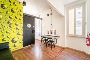 a dining room with a table and a yellow wall at Rooms Piramide in Rome
