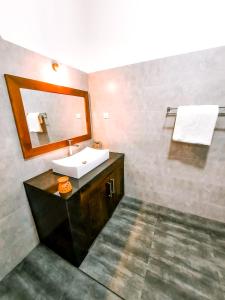 W łazience znajduje się umywalka i lustro. w obiekcie Villa Paradise Ocean w mieście Bentota