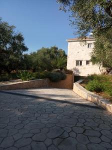 a stone walkway in front of a building at Olive Trees in Tragaki