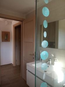 a bathroom with a sink and a mirror at Olive Trees in Tragaki