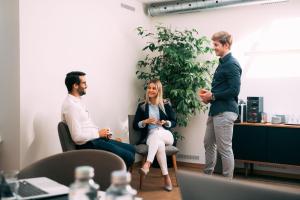 a group of three people in an office talking at Hotel Wettstein in Basel