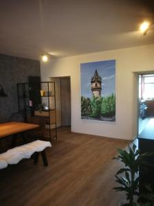 a living room with a picture of a tower on the wall at AppartementHaus Nienburg in Nienburg