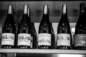 a row of wine bottles sitting on a shelf at La Maison in Aymavilles