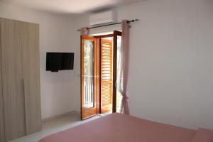 une chambre avec un lit et une porte coulissante en verre dans l'établissement LA CASETTA DI ASIA, à Vico Equense