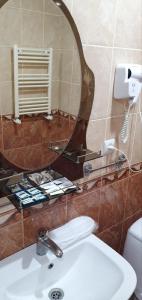 a bathroom with a sink and a mirror at Odzun Hotel in Alaverdi