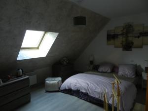 a bedroom with a bed and a window at chambres d'hôtes naturistes de la moque souris in Saint-Pierre-de-Mailloc +19 photos