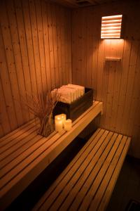 a sauna with two candles sitting on a shelf at Femmasteren Hotel & Hostel in Marstal