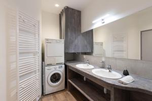 a bathroom with two sinks and a washer and dryer at Les Joyaux Tournusiens in Tournus +41 photos