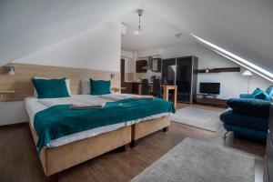 a bedroom with a large bed and a living room at Mango Apartments in Budapest