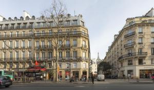 un bâtiment dans une rue de la ville avec des gens et des voitures dans l'établissement Royal Saint Michel, à Paris