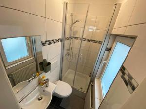 a bathroom with a shower and a toilet and a sink at Apartment with balcony in Lengerich in Lengerich