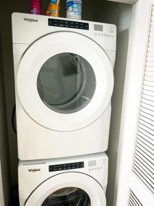 a washer and dryer in a laundry room at Upscale Condo Full Kitchen Balcony Rooftop Pool in Jacksonville