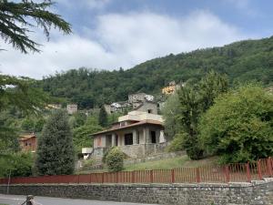 a house on a hill with a fence at Villa Belvedere di Popiglio in Popiglio