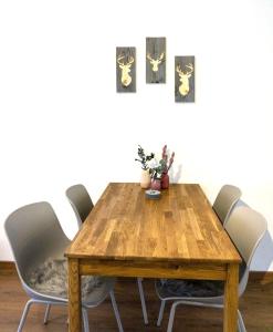 a dining room table with four chairs around it at Balkon mit ruhigem Garten in Sonthofen in Sonthofen