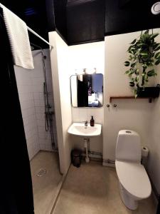 a bathroom with a toilet and a sink at Hotell Temperance in Hudiksvall