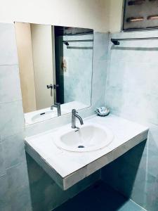 a bathroom with a sink and a mirror at Baan Lamai Resort in Lamai