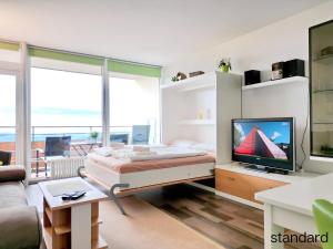 a bedroom with a bed and a tv in it at Ferienpark Geyersberg in Freyung