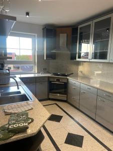 a kitchen with stainless steel appliances and a counter top at Luxuriöse Wohnung im Herzen von RLP in Bobenheim-Roxheim