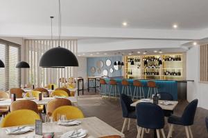 a restaurant with tables and chairs and a bar at HotelHafenWedel in Wedel