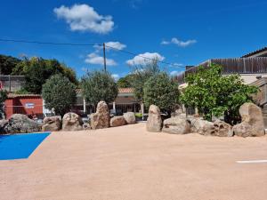 a group of large rocks in a parking lot at H&ocirc;tel Casa di Mama in Porto-Vecchio