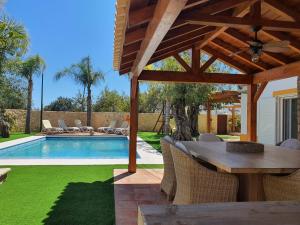 a patio with a table and chairs and a pool at Real Village in Quarteira