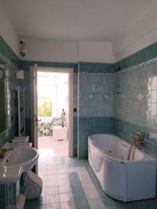ein Badezimmer mit einer Badewanne, einem Waschbecken und einem WC in der Unterkunft B&B Villa Mia in Lanciano