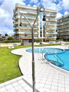 a swimming pool in front of a building at APARTBEACH LARIMAR MUY LUMINOSO y CLIMATIZADO in Salou