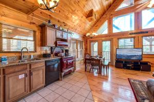 a kitchen with wooden ceilings and a dining room at Hemlock Manor in Gatlinburg