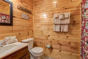 a wooden bathroom with a toilet and a sink at Hemlock Manor in Gatlinburg +22 photos