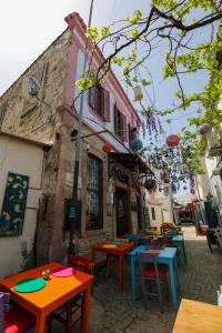 a group of tables in front of a building at Cunda Pera Otel in Ayvalık