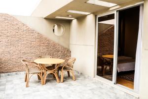 a patio with two tables and chairs and a bed at Circle Club Faisalabad in Faisalabad